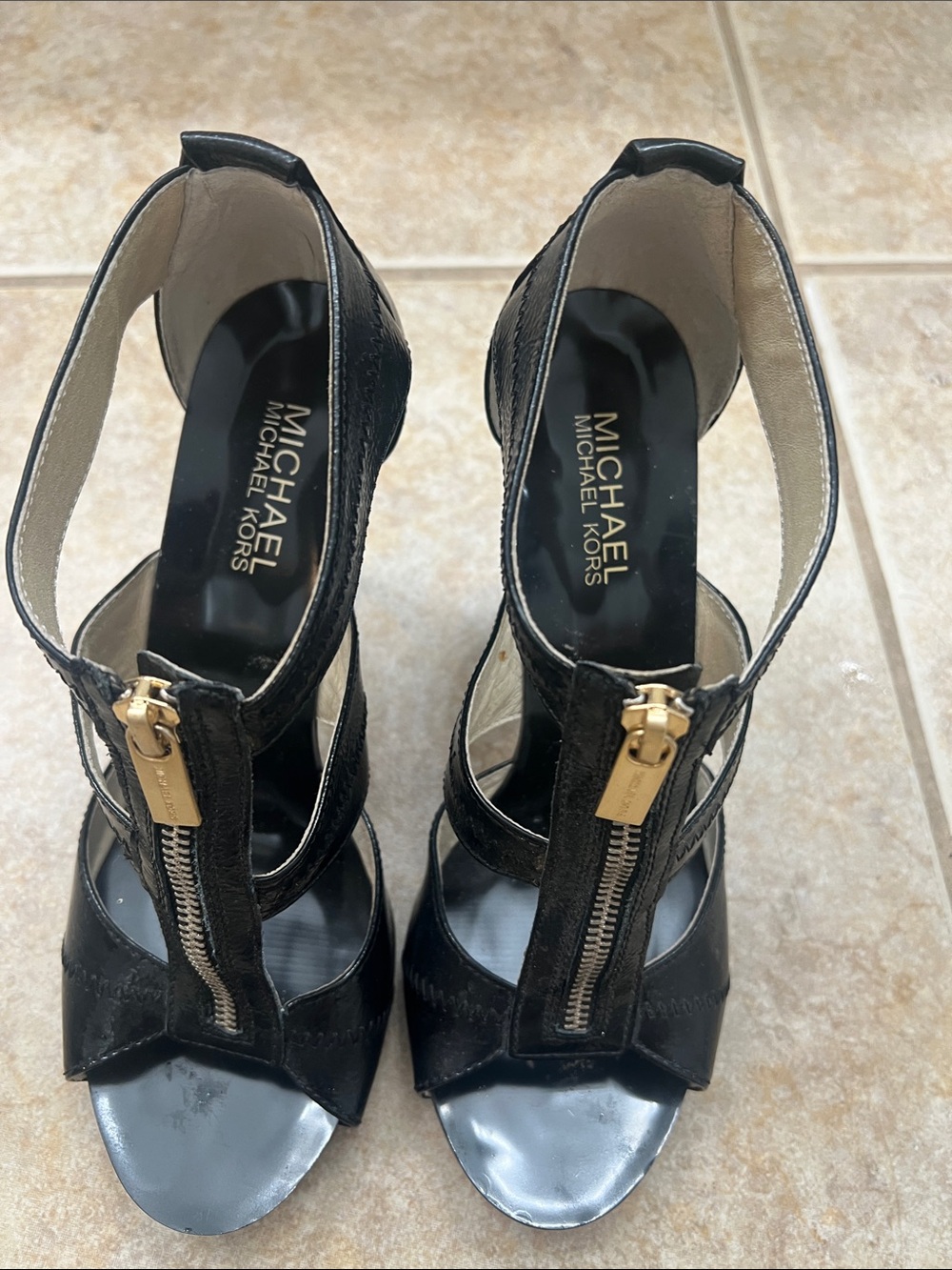 Michael Kors Black Leather Zip-Front Heeled Sandals with Gold Accents.